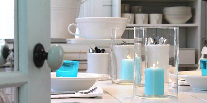 sea foam candles and kartio glasses in table setting